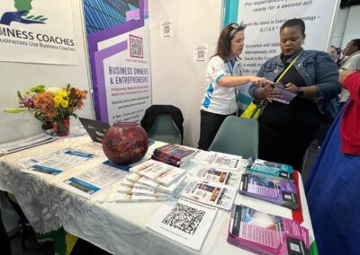 The Stand C31 display table with coaching materials and a South African flag
